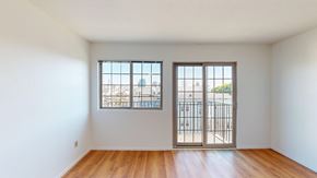 San Francisco apartment for rent - A room with a sliding door and a window overlooking a cityscape.