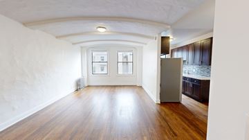 San Francisco apartment for rent - A kitchen with wooden floors and a refrigerator.