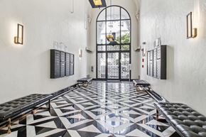 San Francisco apartment for rent - Lobby with a high, arched doorway and large glass panels allow natural light to brighten the space, wall-mounted mailboxes