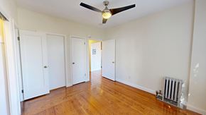 San Francisco apartment for rent - A room with a ceiling fan and a radiator on the floor.