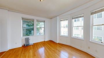 San Francisco apartment for rent - A room with wooden floors and three windows.