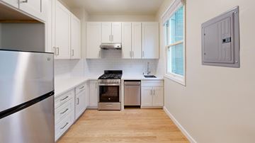 San Francisco apartment for rent - A kitchen with a stainless steel refrigerator and wooden floors.