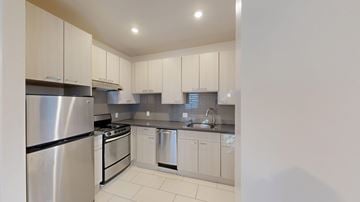 San Francisco apartment for rent - A kitchen with white cabinets and stainless steel appliances.