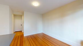 San Francisco apartment for rent - A room with wooden floors and a white door.