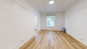 San Francisco apartment for rent - A room with wooden floors and white walls.