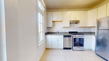 San Francisco apartment for rent - A kitchen with white cabinets and stainless steel appliances.