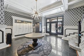 San Francisco apartment for rent - Lobby with geometric wallpaper, mailboxes, an Amazon locker, and a round table beneath a striking chandelier