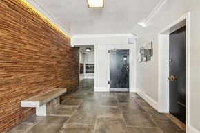 San Francisco apartment for rent - Hallway with a wooden wall and a bench