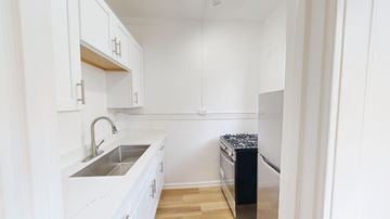 San Francisco apartment for rent - A kitchen with white cabinets and a black dishwasher.