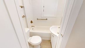 San Francisco apartment for rent - A white toilet sits next to a white bathtub in a bathroom.