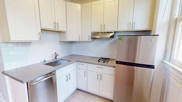 San Francisco apartment for rent - A kitchen with white cabinets and stainless steel appliances.