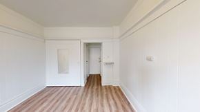San Francisco apartment for rent - A room with white walls and wooden flooring with a door on the right.