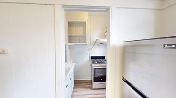 San Francisco apartment for rent - A white kitchen with a stove and a fridge.