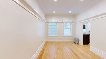 San Francisco apartment for rent - A room with wooden floors and white walls.