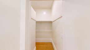 San Francisco apartment for rent - A hallway with a wooden floor and white walls.