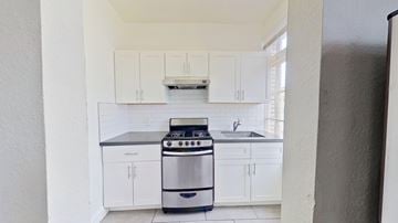 San Francisco apartment for rent - A modern kitchen with white cabinets and a stainless steel oven.