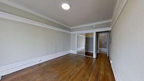 San Francisco apartment for rent - A room with wooden floors and a white ceiling with a light fixture.