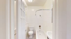 San Francisco apartment for rent - A white bathroom with a toilet, sink, and shower.