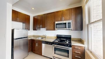 San Francisco apartment for rent - A kitchen with wooden cabinets and stainless steel appliances.