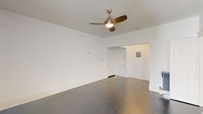 San Francisco apartment for rent - A room with a ceiling fan and a wooden floor.