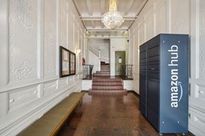 San Francisco apartment for rent - Hallway with ornate walls, terracotta tiles, chandelier, bench, stairs, Amazon Hub locker