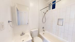 San Francisco apartment for rent - A white bathroom with a toilet, sink, and bathtub.