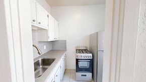 San Francisco apartment for rent - A small kitchen with a sink, stove, and refrigerator.