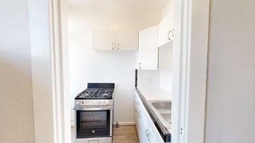 San Francisco apartment for rent - A kitchen with a stove top oven and a sink.