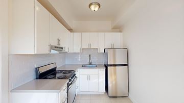 San Francisco apartment for rent - A kitchen with white cabinets and appliances.