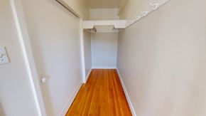 San Francisco apartment for rent - A long hallway with a wooden floor and white walls.