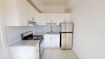 San Francisco apartment for rent - A white kitchen with a stove, sink, and refrigerator.
