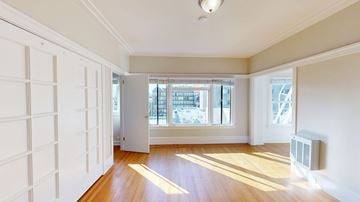 San Francisco apartment for rent - A room with white walls and wooden flooring with a window and a door.
