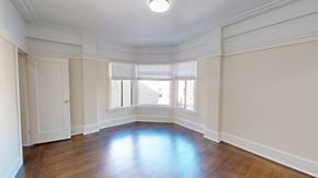 San Francisco apartment for rent - A large empty room with wooden floors and white walls.