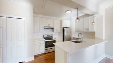 San Francisco apartment for rent - A white kitchen with a sink and a refrigerator.