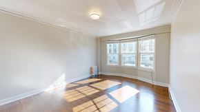 San Francisco apartment for rent - A room with a large window and wooden flooring.
