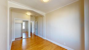 San Francisco apartment for rent - A long hallway with wood floors and white walls.