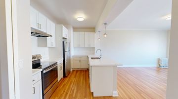 San Francisco apartment for rent - A kitchen with white appliances and wooden floors.