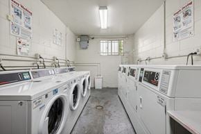 Berkeley apartment for rent - Laundry room with washing machines neatly arranged on a wooden floor