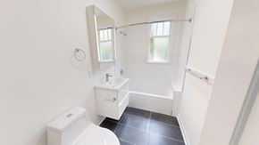 San Francisco apartment for rent - A white bathroom with a toilet, sink, and shower.
