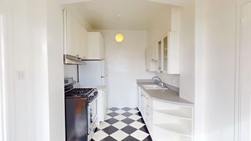 San Francisco apartment for rent - A black and white checkered floor in a white kitchen.