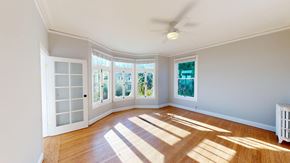 San Francisco apartment for rent - A room with a wooden floor and a ceiling fan.