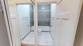San Francisco apartment for rent - A white bathroom with a toilet and a walk-in shower.