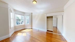 San Francisco apartment for rent - A room with wooden floors and a large window.