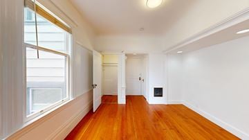 San Francisco apartment for rent - A room with wooden floors and white walls.
