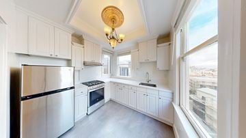 San Francisco apartment for rent - A kitchen with white cabinets and a stainless steel refrigerator.