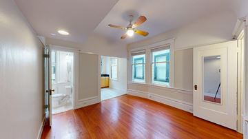 San Francisco apartment for rent - A room with a ceiling fan and hardwood floors.