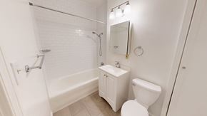San Francisco apartment for rent - A white bathroom with a toilet, sink, and shower.