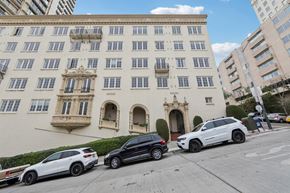 San Francisco apartment for rent - a large building with cars parked in front of it