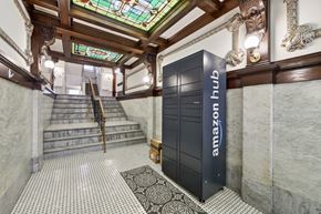San Francisco apartment for rent - A tall black Amazon Hub lobby unit sits in front of a staircase.