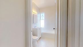 San Francisco apartment for rent - A white bathroom with a toilet, sink, and window.